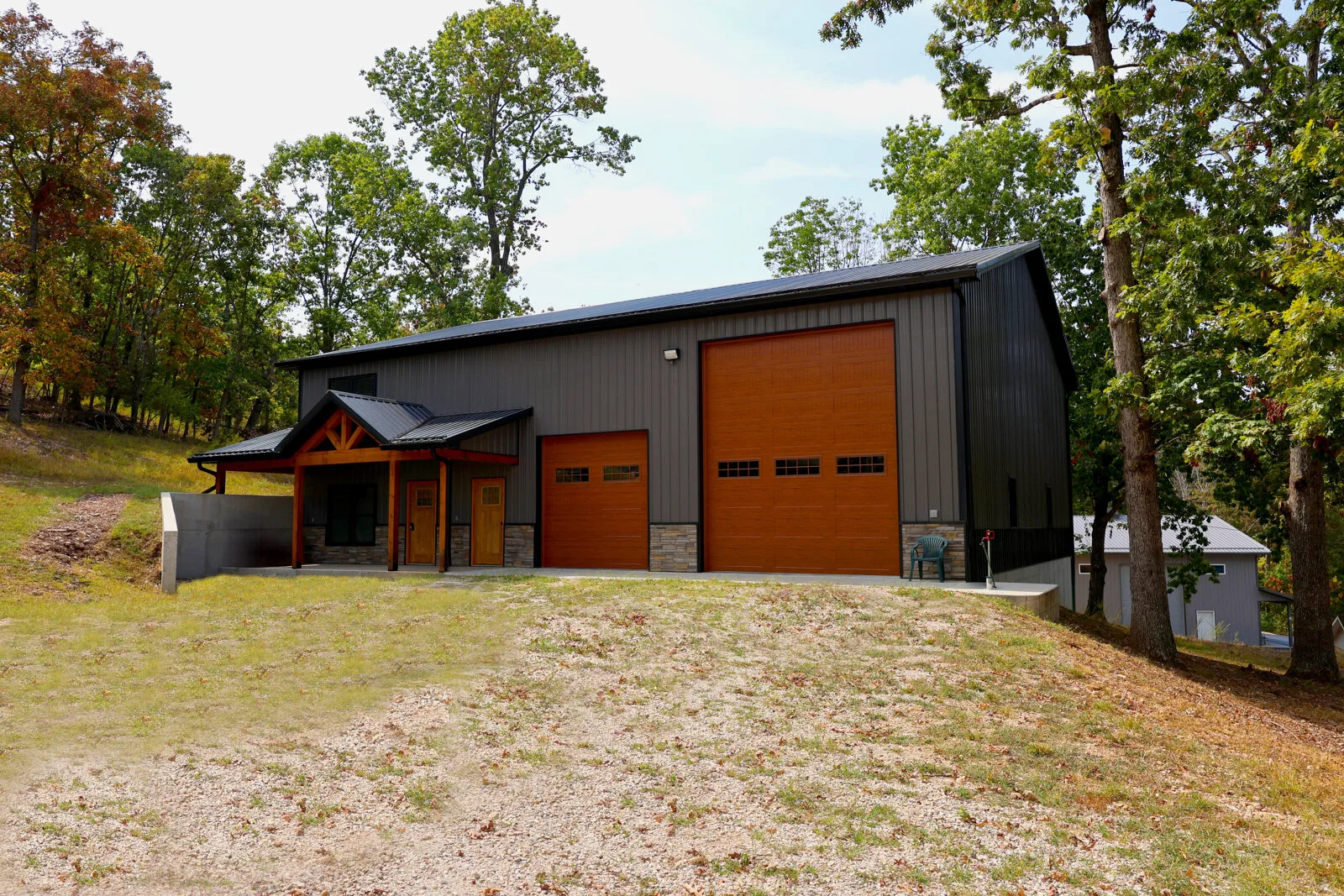 Dark steel barndominium with wood shop doors